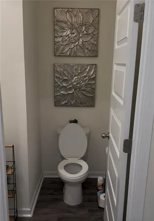 a white toilet sitting next to a small bathroom