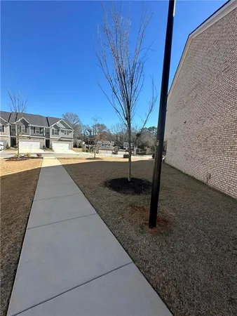 a view of a swimming pool with a yard and sitting area