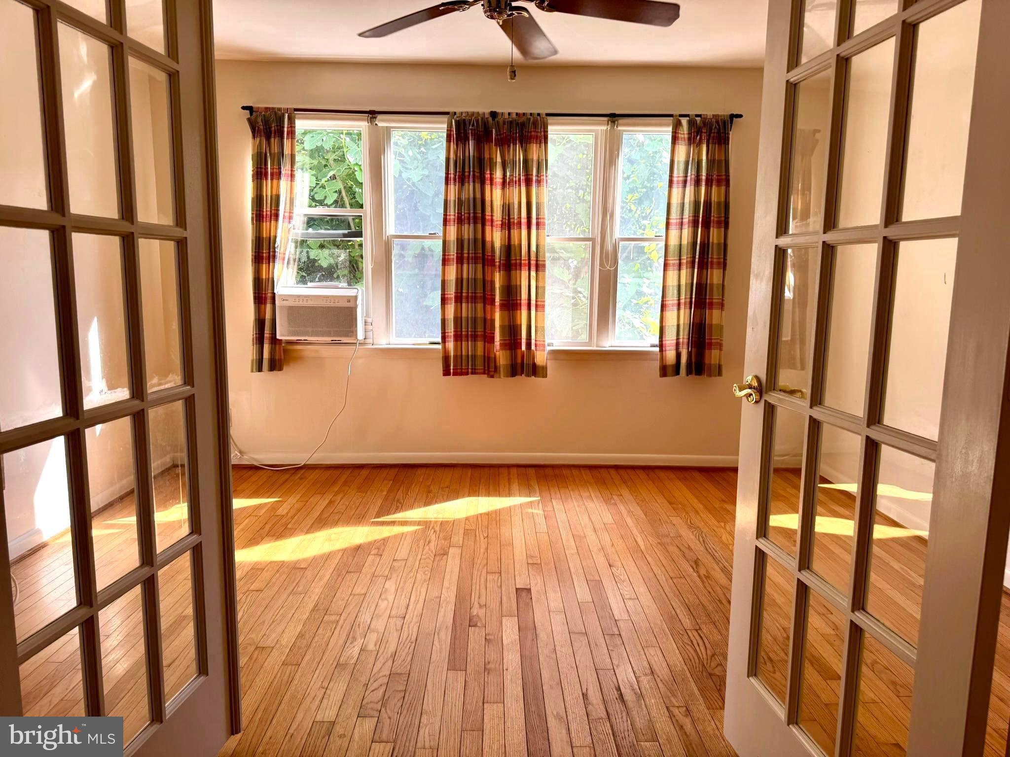 7200 Highland Street Springfield, VA 22150 - Photo 11 of 29 a view of an empty room with wooden floor and a window