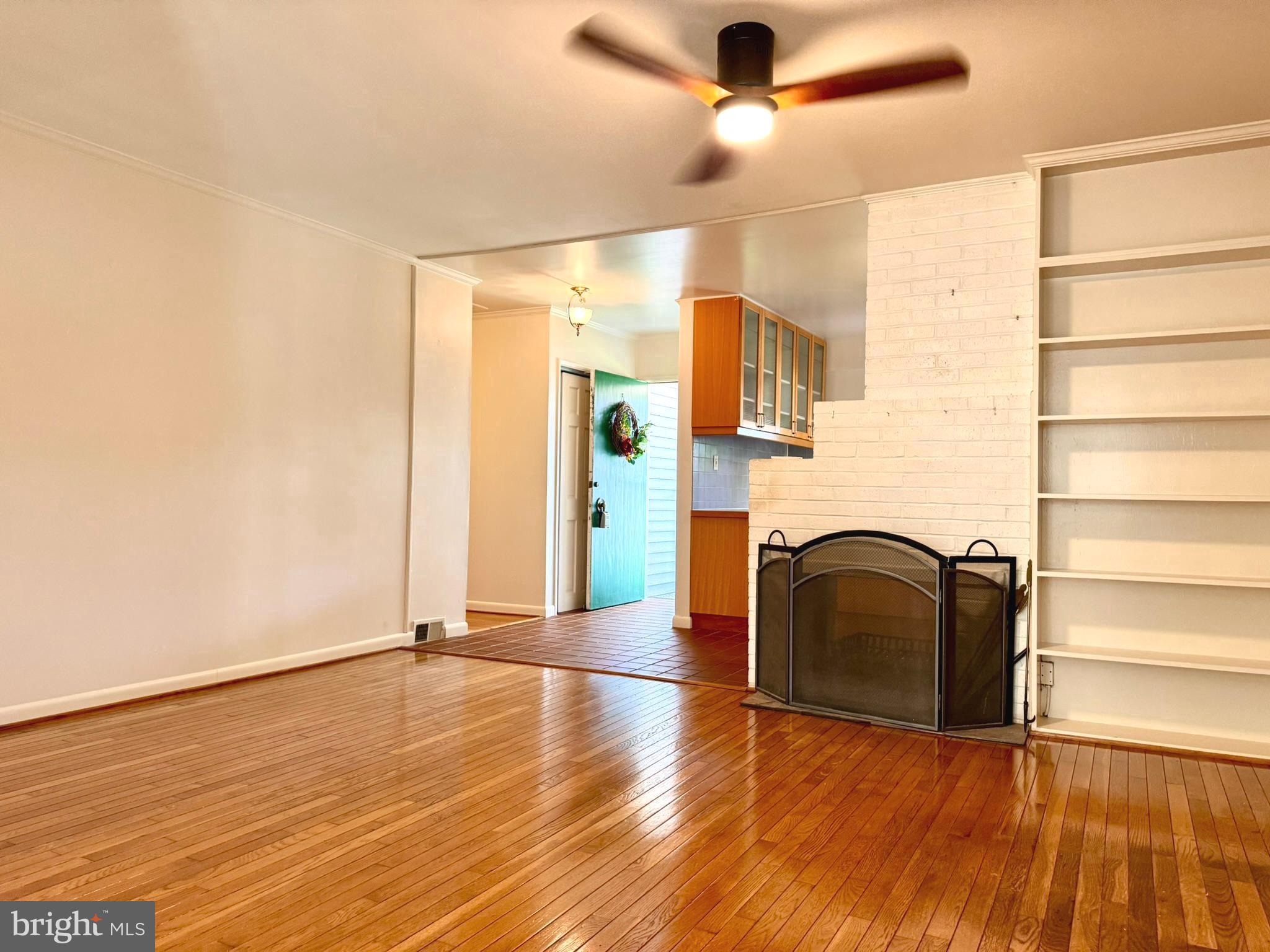 7200 Highland Street Springfield, VA 22150 - Photo 12 of 29 an empty room with wooden floor fan and windows