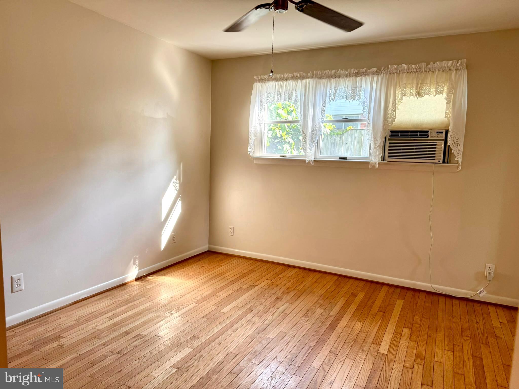 7200 Highland Street Springfield, VA 22150 - Photo 15 of 29 an empty room with wooden floor mirror and windows
