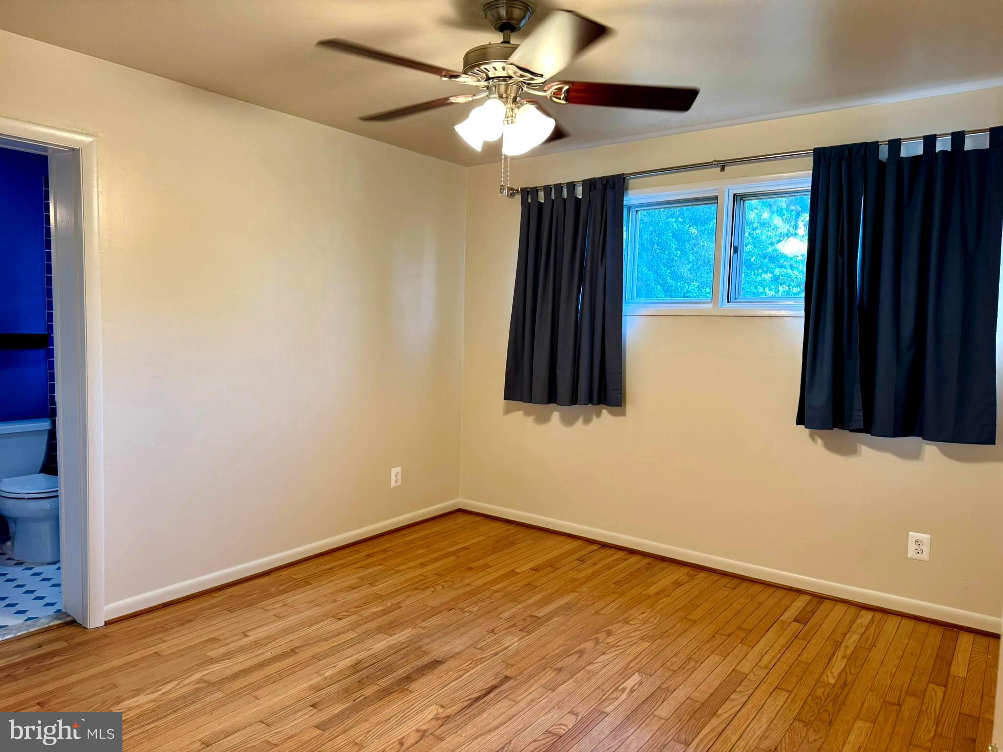 7200 Highland Street Springfield, VA 22150 - Photo 16 of 29 a view of an empty room with window and wooden floor