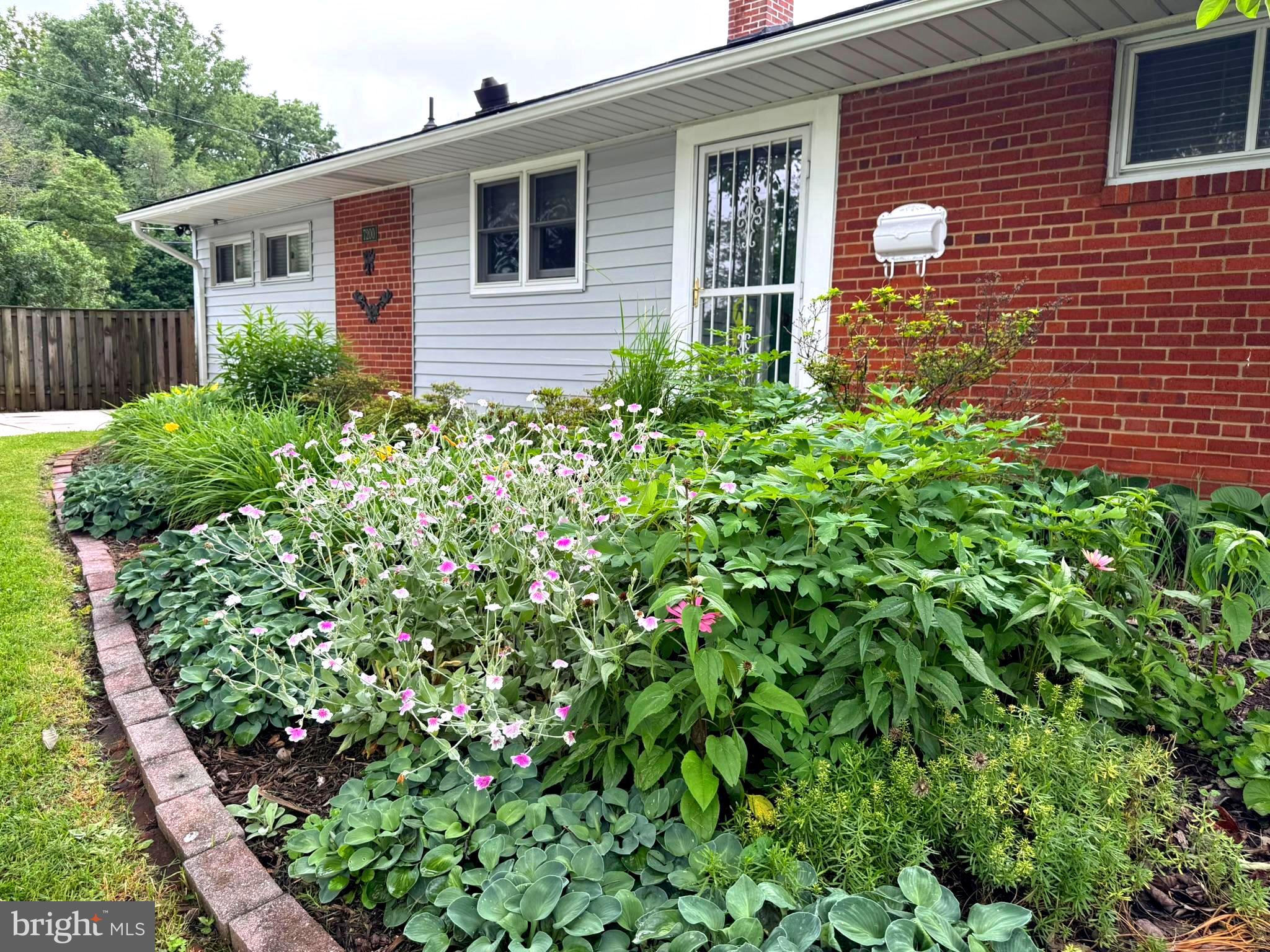 7200 Highland Street Springfield, VA 22150 - Photo 2 of 29 a view of a house with a flower garden