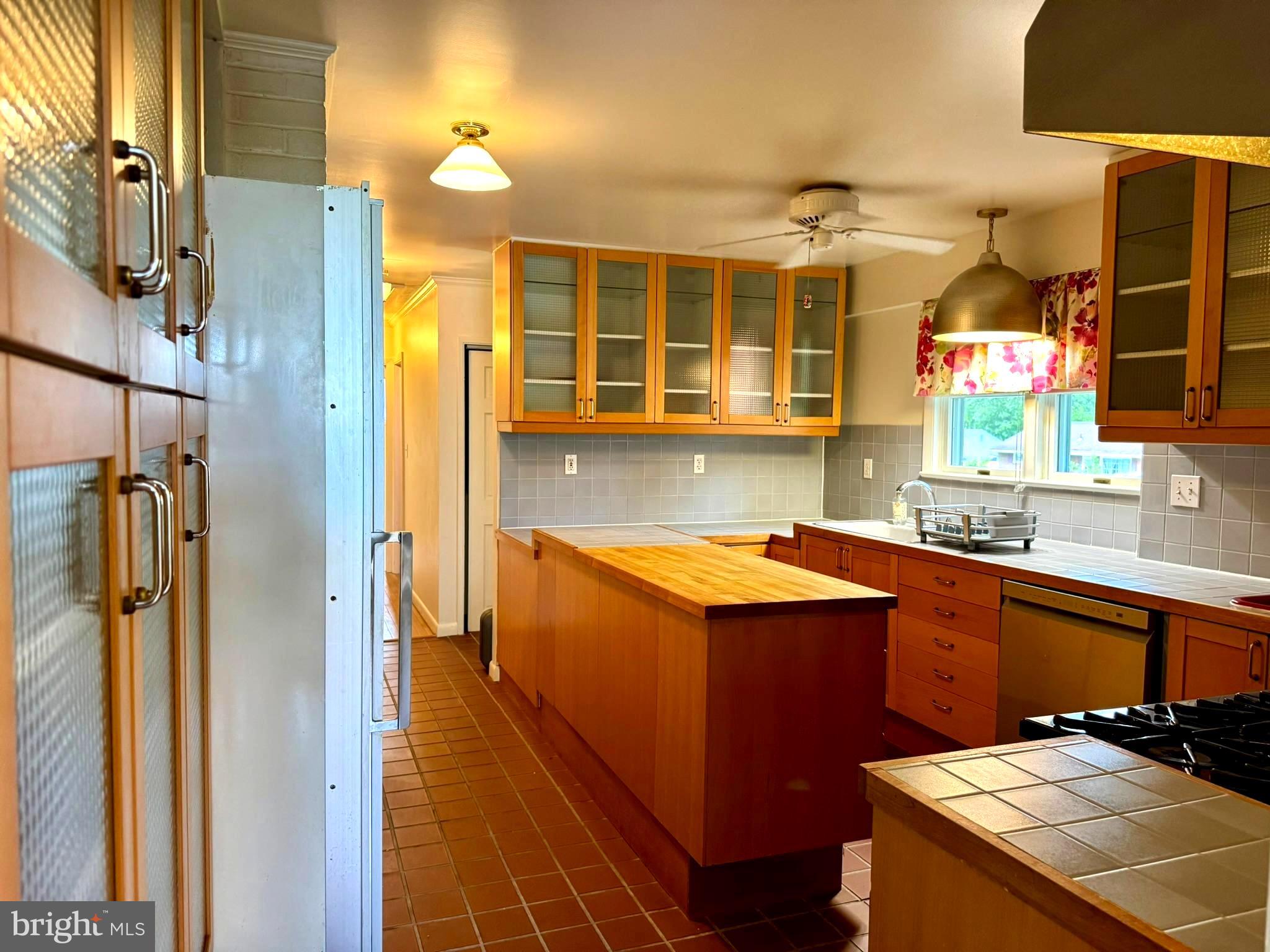 7200 Highland Street Springfield, VA 22150 - Photo 8 of 29 a kitchen with stainless steel appliances granite countertop a sink and a refrigerator