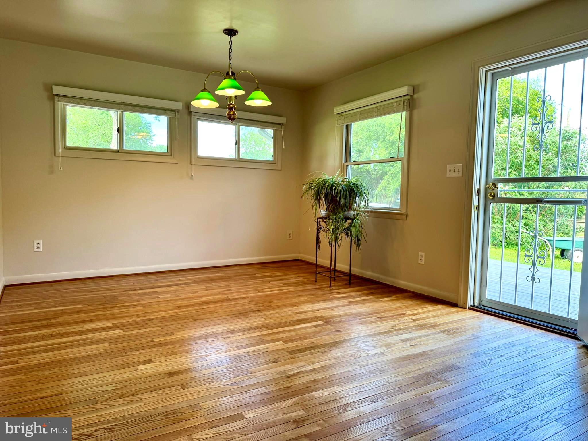 7200 Highland Street Springfield, VA 22150 - Photo 9 of 29 a view of an empty room with wooden floor and a window