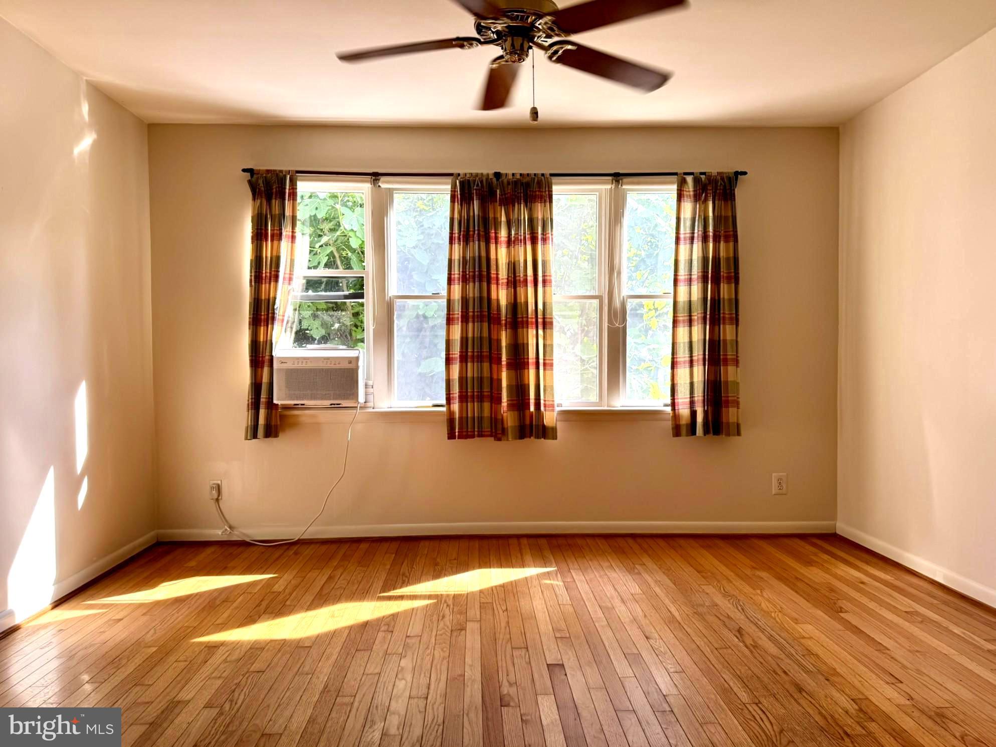 7200 Highland Street Springfield, VA 22150 - Photo 10 of 29 a view of an empty room with wooden floor and a window