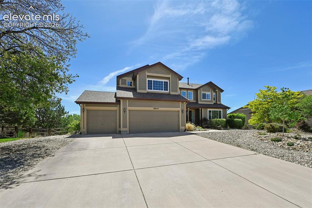 10643 Pictured Rocks Drive Peyton, CO 80831 - Photo 32 of 37 a front view of a house with a yard and garage