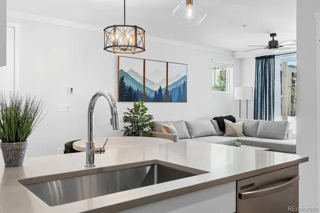 a bedroom with a sink and a flat screen tv
