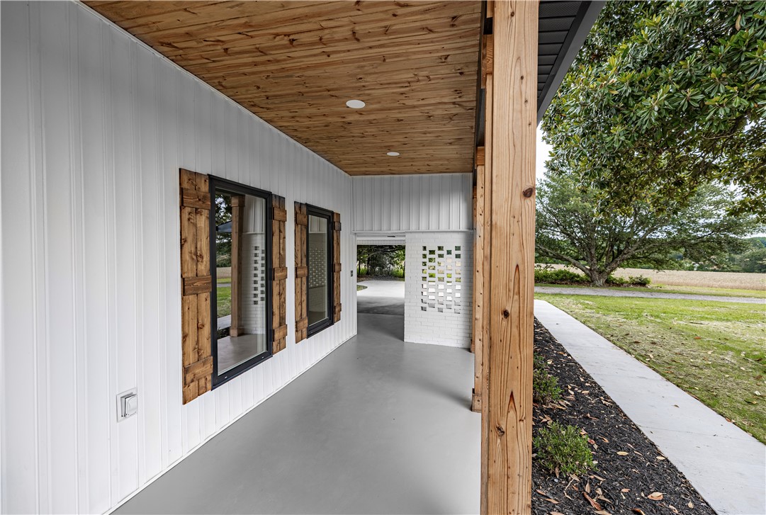 2817 Broadway Lake Road Anderson, SC 29621 - Photo 5 of 41 A well-lit porch entrance features striking wood accents and clean lines.