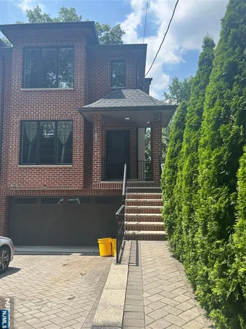 a view of a brick house with many windows