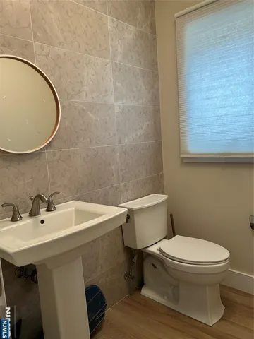 a white toilet sitting next to a bathroom sink