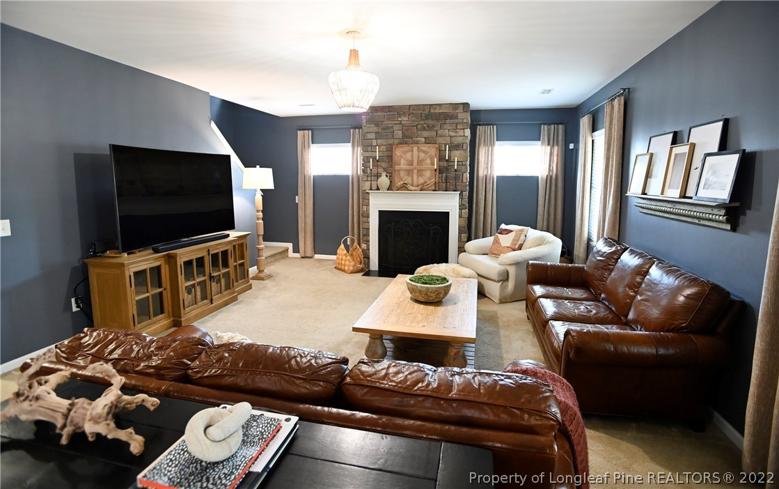 43 Lancaster Court Spring Lake, NC 28390 - Photo 15 of 44 a living room with furniture a flat screen tv and a fireplace