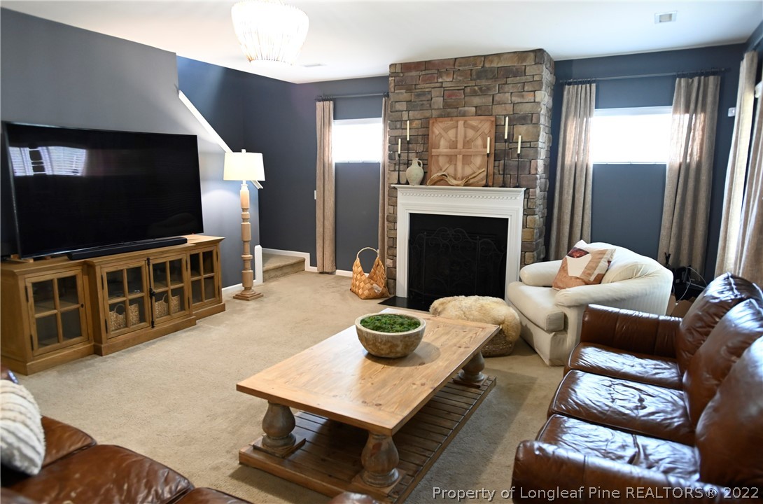 43 Lancaster Court Spring Lake, NC 28390 - Photo 16 of 44 a living room with furniture a flat screen tv and a fireplace