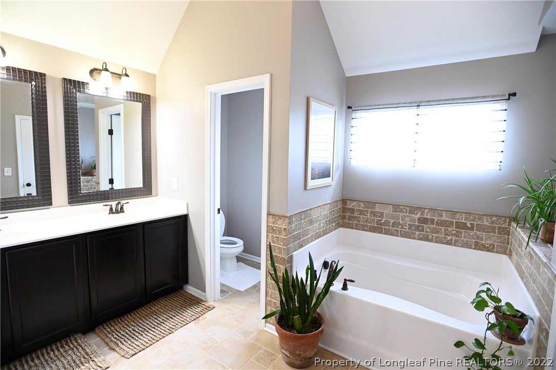 43 Lancaster Court Spring Lake, NC 28390 - Photo 26 of 44 a bath room with a sink tub shower and a mirror