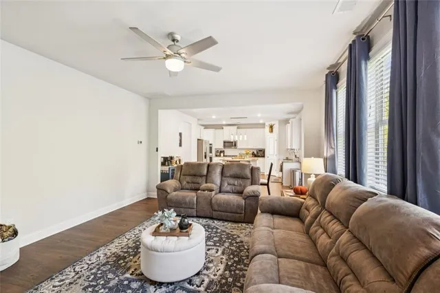 a spacious bedroom with a large bed and a chandelier