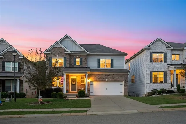 a front view of a house with a yard