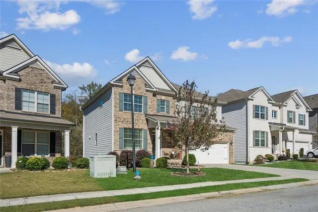 a front view of a building with that has a yard
