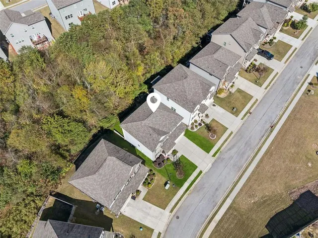 an aerial view of a house with a yard