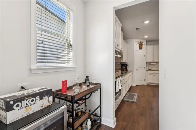 a kitchen with stainless steel appliances granite countertop a refrigerator and microwave