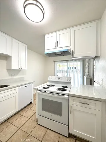 a kitchen with cabinets appliances and a sink