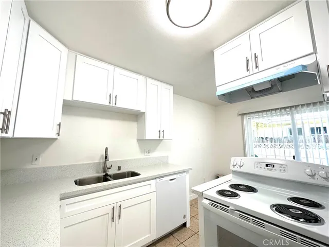 a kitchen with appliances cabinets and a sink