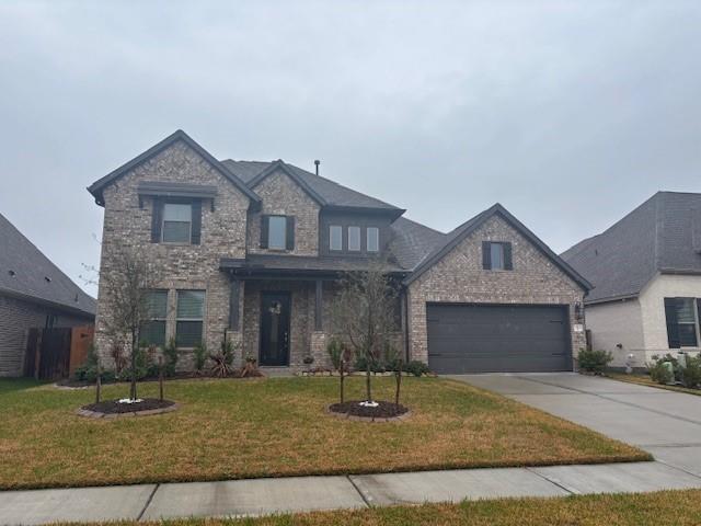 32339 Mossy Pine Way Spring Conroe, TX 77385 - Photo 1 of 6 a front view of a house with garden