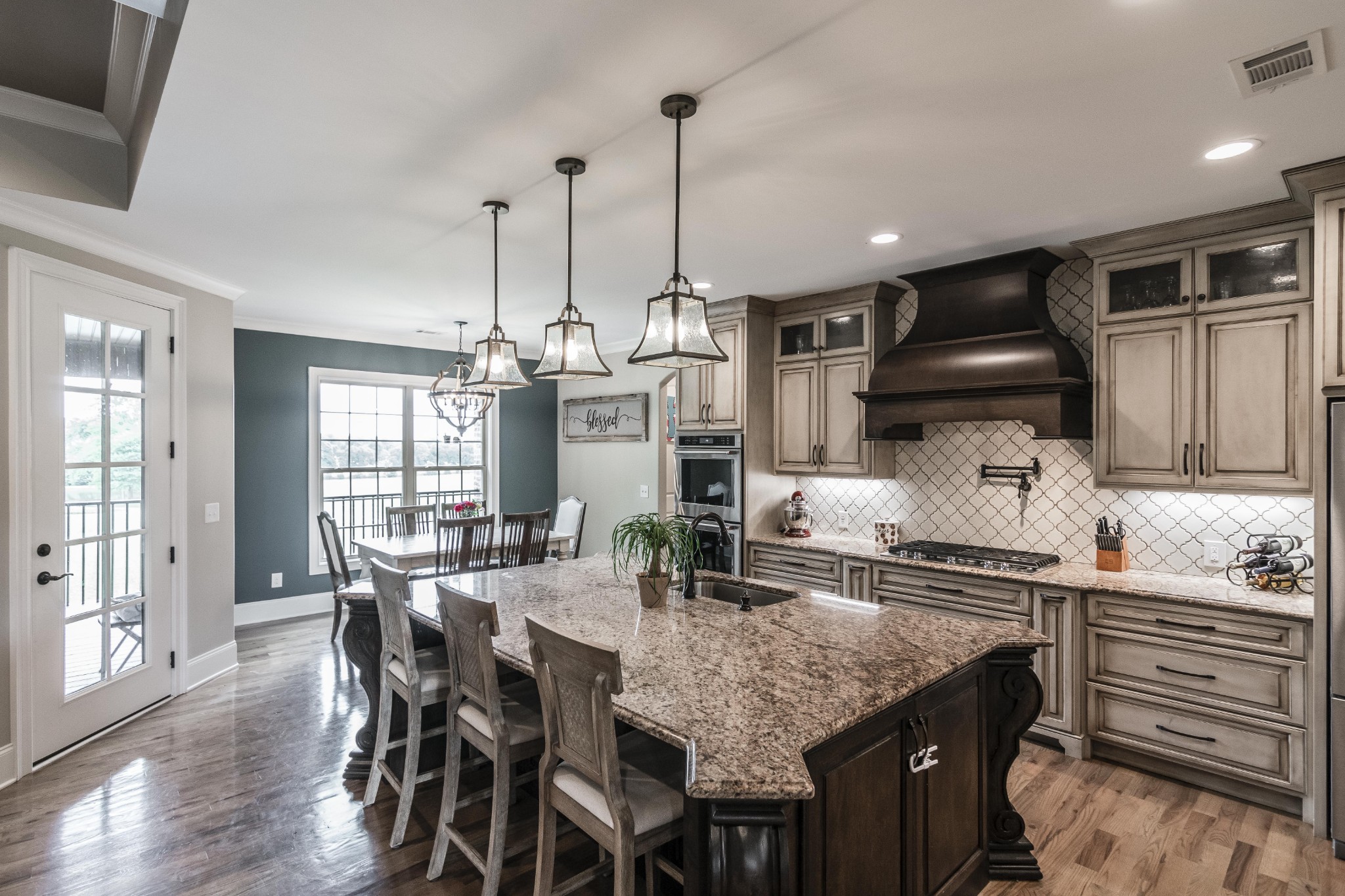 4294 Dot Road Springfield, TN 37172 - Photo 23 of 50 a kitchen with granite countertop a stove a sink a dining table and chairs