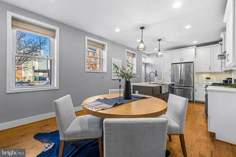 a kitchen with stainless steel appliances a stove a sink and a refrigerator