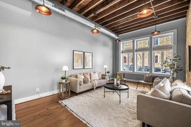 a living room with patio furniture and a chandelier