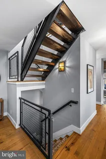 a view of a hallway with wooden door and a window