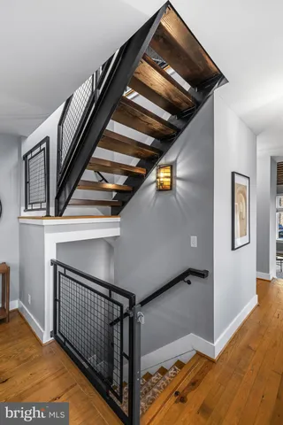 a view of a hallway with wooden door and a window