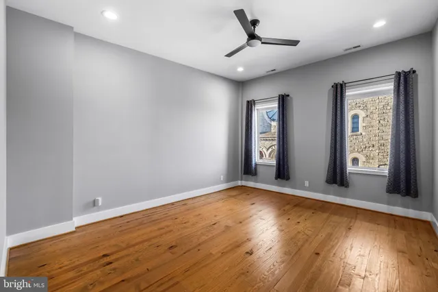 a view of an empty room with wooden floor