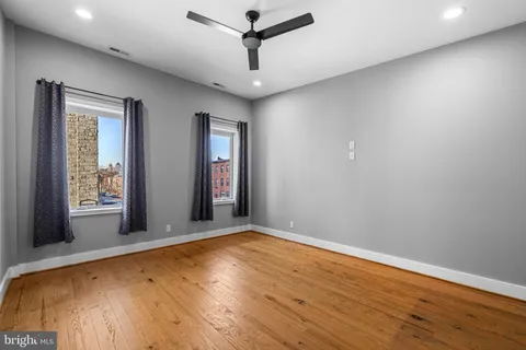a view of walk in closet with empty racks