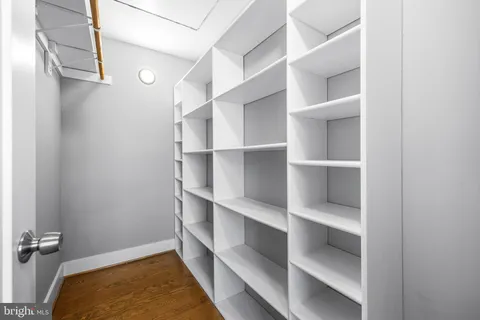 a view of a hallway with wooden floor and stairs