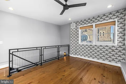 a view of a balcony with wooden floor and fence