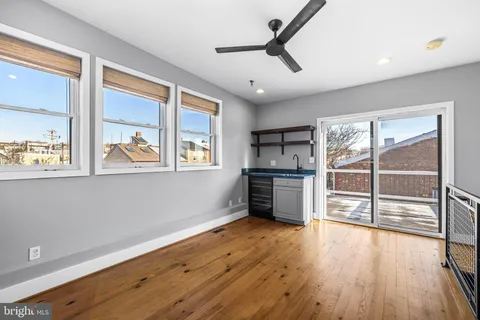a view of a balcony with wooden floor and fence