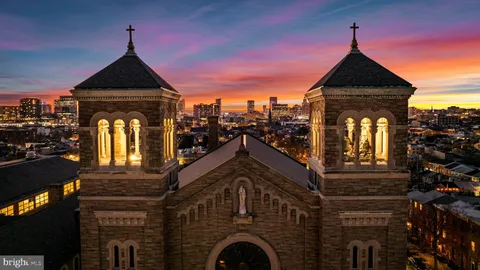 a kitchen with a table chairs and white cabinets