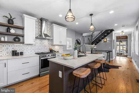 a kitchen with a refrigerator a stove a sink and a cabinets