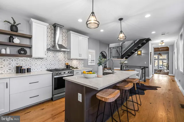 a kitchen with a refrigerator a stove a sink and a cabinets