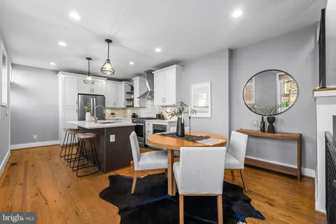 a dining room with furniture and wooden floor