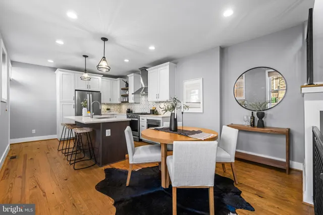 a dining room with furniture and wooden floor
