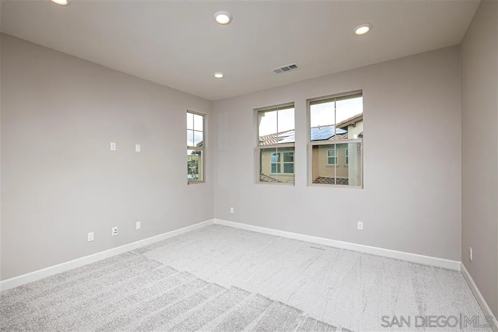 1174 Delpy View Point, Unit 102 Vista, CA 92084 - Photo 12 of 17 an empty room with windows