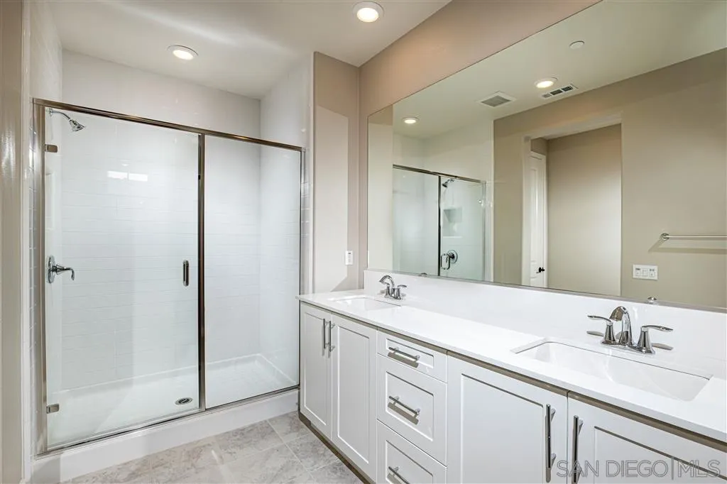 1174 Delpy View Point, Unit 102 Vista, CA 92084 - Photo 13 of 17 a bathroom with a granite countertop sink mirror and double