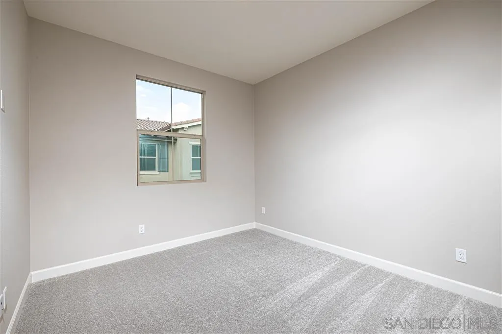 1174 Delpy View Point, Unit 102 Vista, CA 92084 - Photo 15 of 17 an empty room with a window