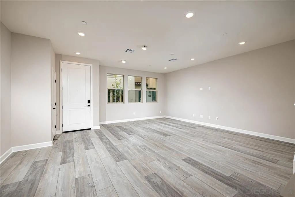 1174 Delpy View Point, Unit 102 Vista, CA 92084 - Photo 3 of 17 a view of an empty room with wooden floor