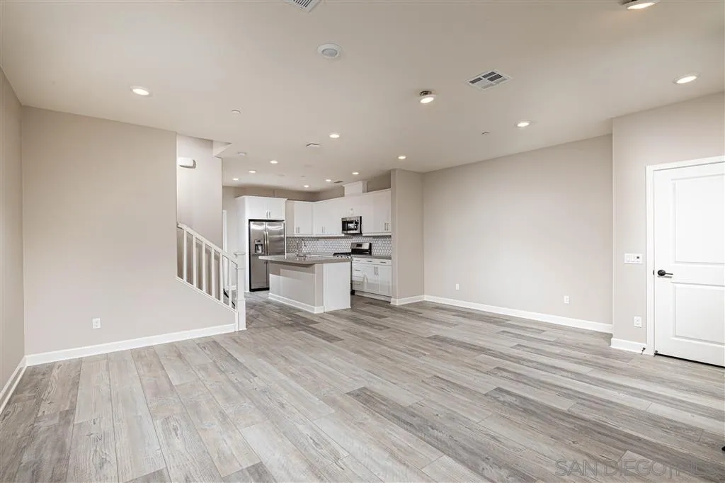 1174 Delpy View Point, Unit 102 Vista, CA 92084 - Photo 4 of 17 a view of kitchen with wooden floor