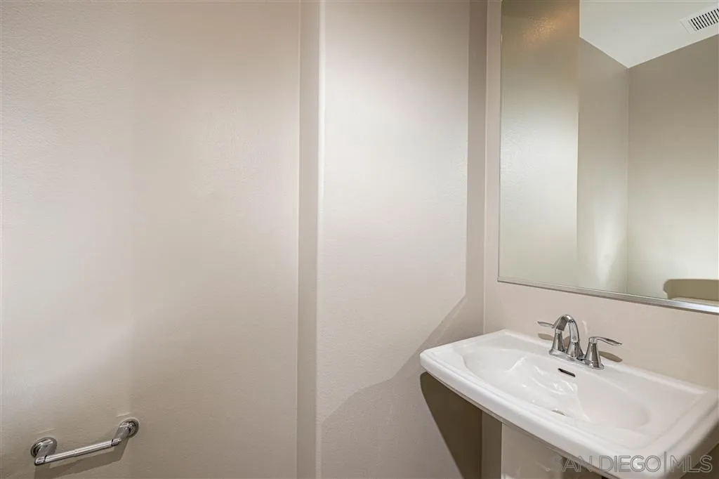 1174 Delpy View Point, Unit 102 Vista, CA 92084 - Photo 9 of 17 a bathroom with a sink and a mirror