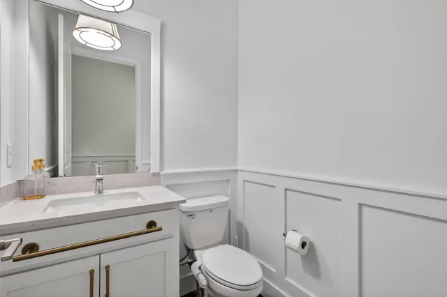 a view of a room with wooden floor table and chairs