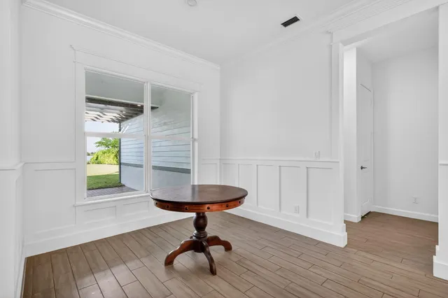 wooden floor in an empty room with a window