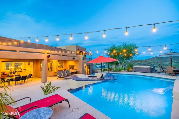 a living room with patio furniture and a potted plant